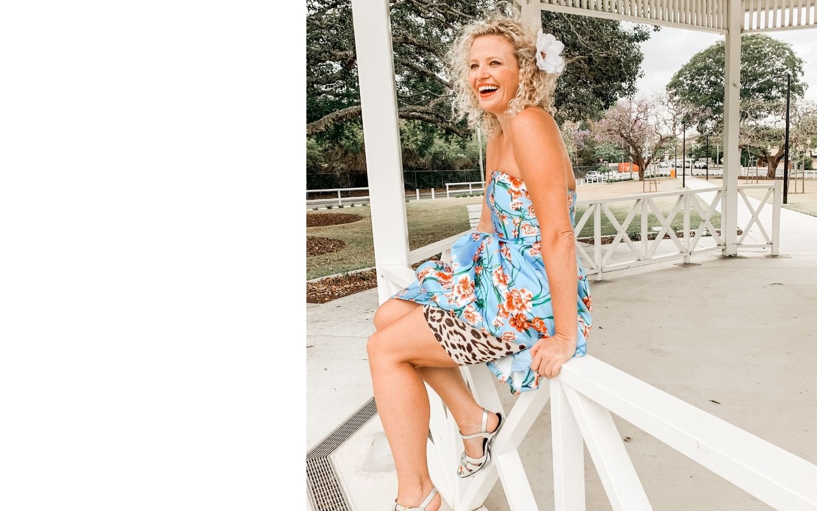 Susie Taaffe smiling in a blue floral dress